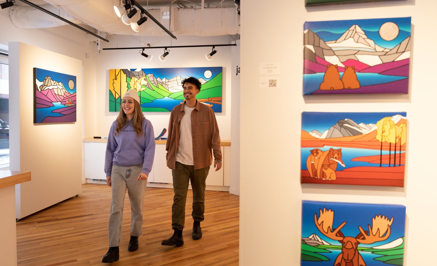 Two people walk through the Ryan Carter Gallery in Banff National Park.